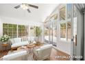Bright sunroom with floor-to-ceiling windows and modern furniture, perfect for relaxation at 4521 Crimson Leaf Dr, Las Vegas, NV 89130