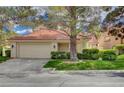 Charming single-Gathering home with mature trees, lush lawn, and a two-car garage at 5112 Onion Creek Ln, Las Vegas, NV 89113