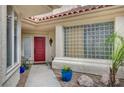 Inviting front entrance with colorful potted plants and a decorative glass block window feature at 5112 Onion Creek Ln, Las Vegas, NV 89113