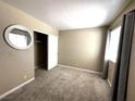 Bedroom featuring neutral walls, carpet, closet, and window with curtains at 5188 River Glen Dr # 453, Las Vegas, NV 89103