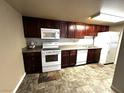 Kitchen featuring dark wood cabinets, a complete appliance package, and tile flooring at 5188 River Glen Dr # 453, Las Vegas, NV 89103