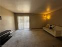 Living room with a sliding glass door and comfortable seating arrangement at 5188 River Glen Dr # 453, Las Vegas, NV 89103