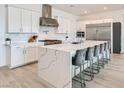 The kitchen features a large marble waterfall island with seating, stainless steel appliances, and custom cabinetry at 5321 Brayden Ct, Las Vegas, NV 89131