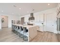Bright kitchen features stainless steel appliances, a large waterfall island with seating, and custom cabinetry at 5321 Brayden Ct, Las Vegas, NV 89131
