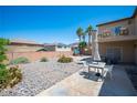 Spacious backyard with patio area, desert landscaping, and a balcony overlooking the space at 54 Blue Fountain Ct, Henderson, NV 89012
