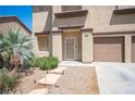 Inviting front entrance with decorative stone walkway, desert plants, and a secure storm door at 54 Blue Fountain Ct, Henderson, NV 89012