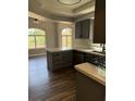 Bright kitchen showcases stylish cabinets, countertop, and wood-look floors at 541 Indian Bluff St # 201, Las Vegas, NV 89145