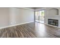 Open living room with wood floors, fireplace, and sliding doors to private balcony at 541 Indian Bluff St # 201, Las Vegas, NV 89145