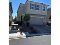 Two-story home with two-car garage, desert landscaping and green shuttered windows at 5550 Jinan St, Las Vegas, NV 89148