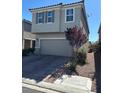 Two-story home with a two-car garage and desert landscaping at 5550 Jinan St, Las Vegas, NV 89148