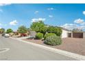 Charming home with a stone-accented facade, well-manicured landscaping, and a spacious two-car garage at 564 Lampshire Ln, Pahrump, NV 89060