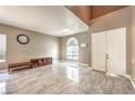 Bright living room with tile floors, a large window, and neutral walls at 5862 Bluthe Bridge Ave, Las Vegas, NV 89141