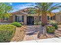 Inviting home exterior with manicured landscaping, decorative iron gate, and brick pathway at 6227 Orto Vaso Ave, Las Vegas, NV 89131