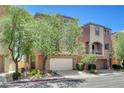 Charming two-story home featuring a stucco facade, with a two-car garage, and manicured front yard at 6622 Colorado Spruce St, Las Vegas, NV 89149
