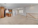 Bright, open-concept living space featuring neutral carpeting and an adjacent eat-in kitchen at 6622 Colorado Spruce St, Las Vegas, NV 89149