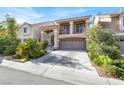 Two-story home with a two-car garage, a balcony, and desert landscaping at 6726 Glissando Ct, Las Vegas, NV 89139