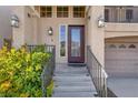 Home's front door with decorative glass, sidelight, and outdoor lighting at 6726 Glissando Ct, Las Vegas, NV 89139