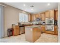 Well-lit kitchen boasts stainless steel appliances, granite countertops, and ample cabinet space at 7042 Grand Junction Ave, Las Vegas, NV 89179