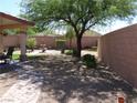 Spacious backyard with a water fountain, patio seating, and a well-maintained landscape at 711 Golden Sedum Dr, Henderson, NV 89011