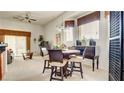 Cozy dining area with a marble table, comfortable chairs, and natural light at 711 Golden Sedum Dr, Henderson, NV 89011