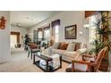 Bright living room with neutral tones, comfortable seating, and elegant decor at 711 Golden Sedum Dr, Henderson, NV 89011