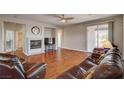 Living area boasts a fireplace, wood floors, and sliding door access to the outdoor space at 7152 Fairwind Acres Pl, Las Vegas, NV 89131