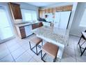 Charming kitchen with stainless appliances, breakfast bar, granite countertops, and ample cabinet space at 7319 Burnt Umber St, Las Vegas, NV 89139