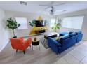 Sun-filled living room with unique wall art, modern furnishings and lots of natural light at 7319 Burnt Umber St, Las Vegas, NV 89139