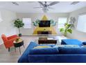 Bright living room with a blue sofa, large windows, and an open layout, great for entertaining at 7319 Burnt Umber St, Las Vegas, NV 89139