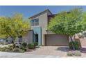 Charming home showcasing modern architecture, complemented by a well-maintained front yard and two-car garage at 8335 Beaten Path Ct, Las Vegas, NV 89166