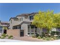 Exterior side view of a modern home with a fence, low maintenance landscaping, and multiple windows at 8335 Beaten Path Ct, Las Vegas, NV 89166