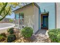 Charming entrance featuring a blue accent wall, stylish door, and professionally maintained landscaping at 8335 Beaten Path Ct, Las Vegas, NV 89166