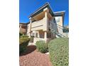 Charming exterior view with lush landscaping, stairs leading to upper units, and a tile roof at 8410 Eldora Ave # 1053, Las Vegas, NV 89117