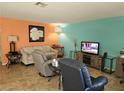Inviting living room with tile flooring, bright accent walls, and comfortable seating arrangement at 8410 Eldora Ave # 1053, Las Vegas, NV 89117