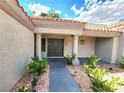 Inviting home entrance featuring double doors, desert landscaping and trimmed plants at 8720 Prairie Hill Dr, Las Vegas, NV 89134