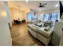 Cozy living room with hardwood floors, modern furnishings and a view into the kitchen at 8720 Prairie Hill Dr, Las Vegas, NV 89134