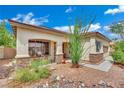 Close up of a stucco house with stone accents and desert landscaping at 9142 Royal Monarch Ct, Las Vegas, NV 89147