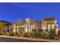 Striking modern home exterior showcasing a unique architectural design, lush landscaping, and inviting curb appeal at 10048 Copper Edge Rd, Las Vegas, NV 89148