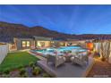 Beautiful backyard pool area, perfect for relaxation and entertainment with its comfortable seating at 10048 Copper Edge Rd, Las Vegas, NV 89148