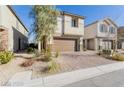 Two-story stucco home with a brick-paved driveway, a brown garage door, and landscaping at 10316 Apefly St, Las Vegas, NV 89141