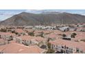 A high-angle showcases an aerial view of the property with mountains in the background at 10550 W Alexander Rd # 2082, Las Vegas, NV 89129