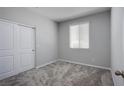 Clean bedroom features neutral walls, plush carpet and large closet for ample storage at 10590 Dryades Ave, Las Vegas, NV 89166