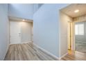 Inviting entryway with vaulted ceilings and wood-look flooring, leading to other rooms at 10590 Dryades Ave, Las Vegas, NV 89166