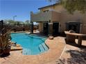 Sparkling backyard pool with rock waterfall and stone patio, perfect for outdoor entertaining at 10601 Turquoise Valley Dr, Las Vegas, NV 89144
