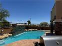 Backyard pool with rock features, providing a tranquil and private outdoor oasis at 10601 Turquoise Valley Dr, Las Vegas, NV 89144