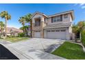 Two-story home with a three-car garage, stone accents, balcony, and green lawn at 10761 Capesthorne Way, Las Vegas, NV 89135