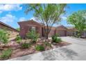 Inviting single-story home with desert landscaping and a convenient two-car garage at 11244 Gammila Dr, Las Vegas, NV 89141