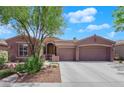 Inviting single-story home with a tiled roof, well-kept landscaping, and a two-car garage at 11244 Gammila Dr, Las Vegas, NV 89141