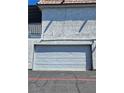 Garage door on a two-story building with a stucco finish at 1128 Willow Tree Dr # C, Las Vegas, NV 89128