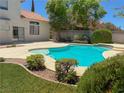 Gorgeous pool area with lush landscaping, perfect for relaxing and enjoying the outdoors at 1564 Silver Knoll Ave, Las Vegas, NV 89123